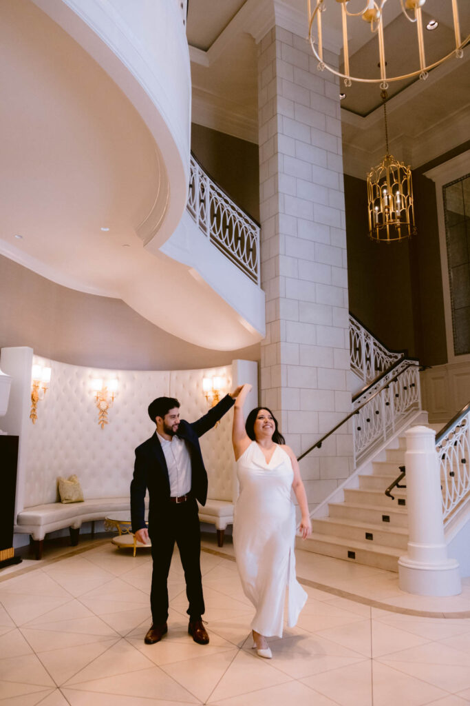 hotel bennett engagement photos of man and woman in white dress and tux 
charleston wedding and engagement photographer near me
luxury wedding photographer charleston
picture of groom spinning bride in hotel bennett