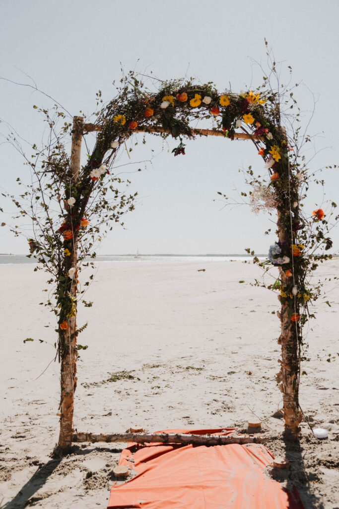 floral archway on beach spring colors 