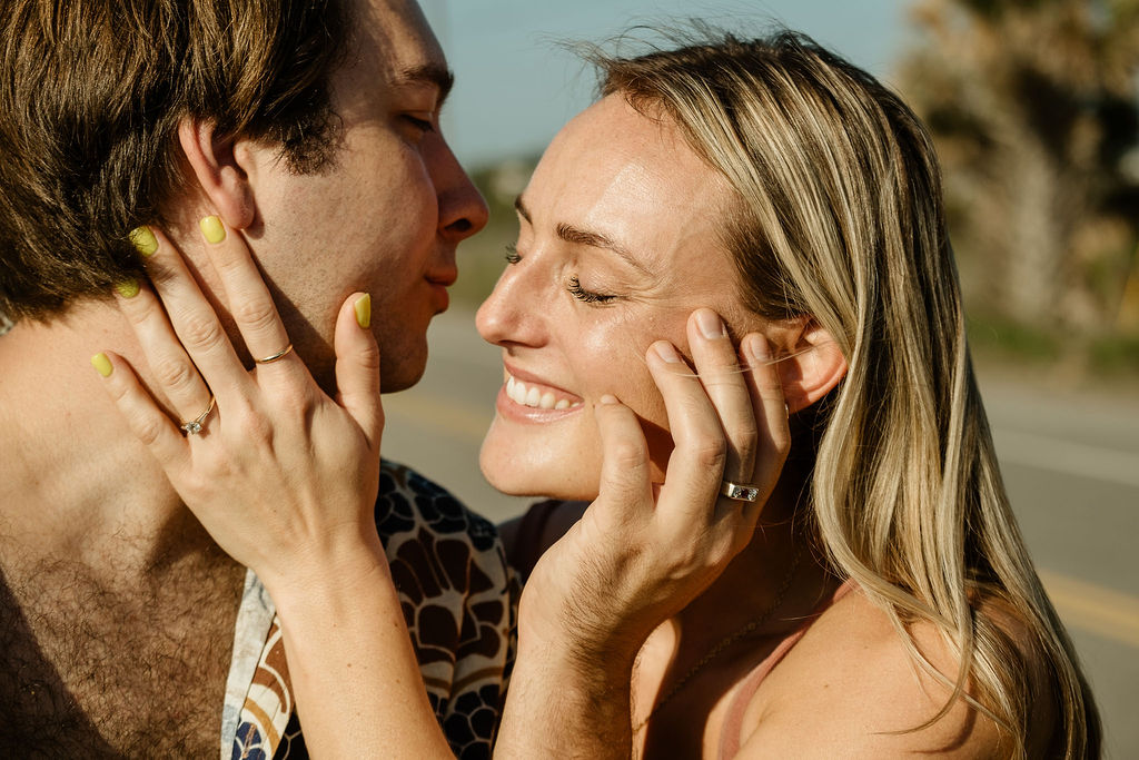 couple documentary engagement shoot on beach kissing