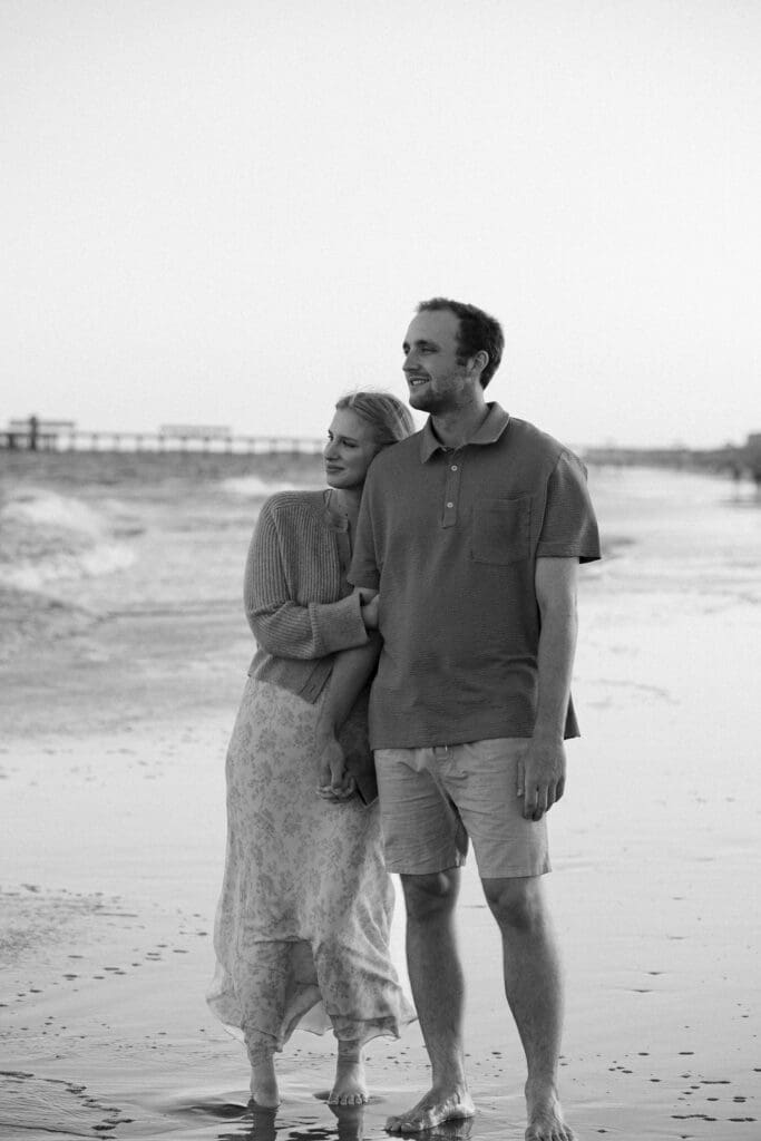 couple walking on beach documentary style photography wedding and engagement black and white