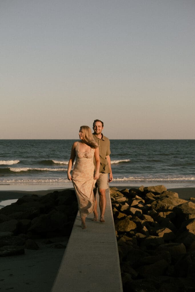 couple walking on beach documentary style photography wedding and engagement