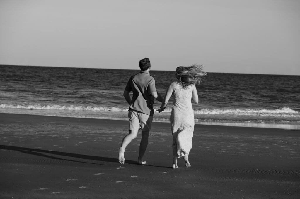 couple running on beach documentary style photography wedding and engagement