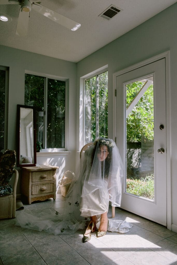 bride getting ready in wedding gown on wedding day documentary wedding photography