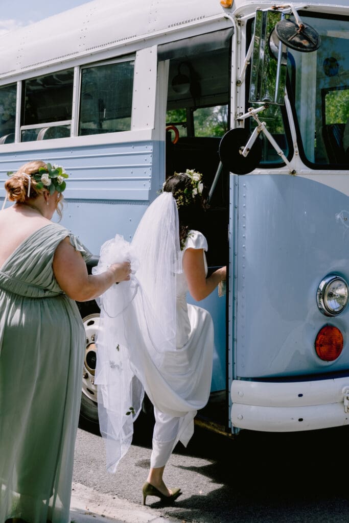 bride getting into vintage trolly or bus blue