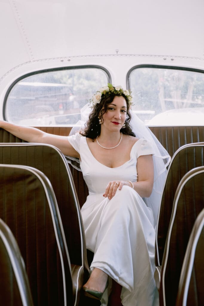 portrait of bride sitting on wedding day on trolly