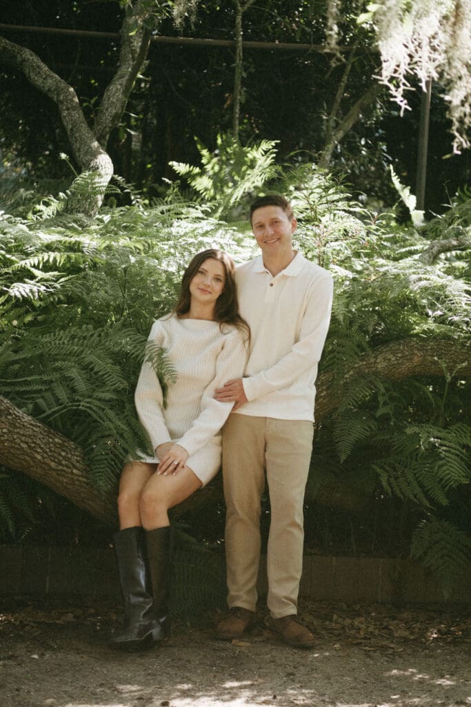 engagement shoot documentary style candid of couple outside under tree hampton park engagement photoshoot