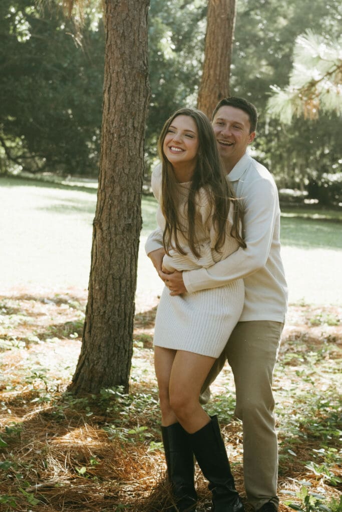 couple hugging and playing documentary engagement shoot hampton park engagement photoshoot