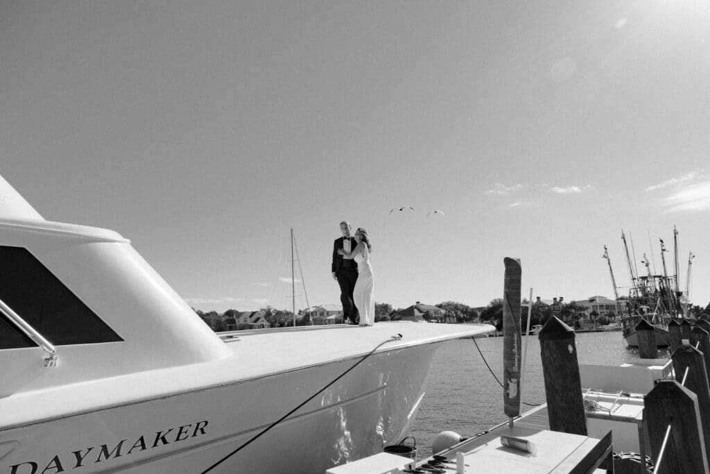 bride and groom editorial style portraits on boat shem creek charleston south carolina in black and white