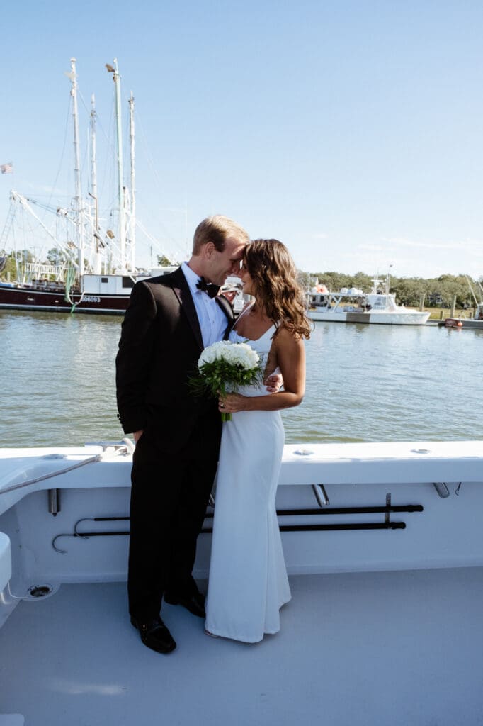 charleston documentary wedding photographer candid couple on boat with couple hugging after first look