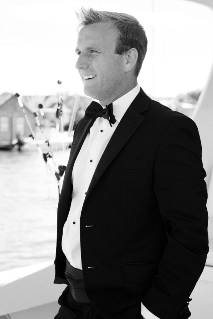 charleston documentary wedding photographer candid groom portrait on boat 