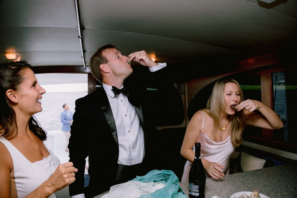 oyster eating on boat bride and groom