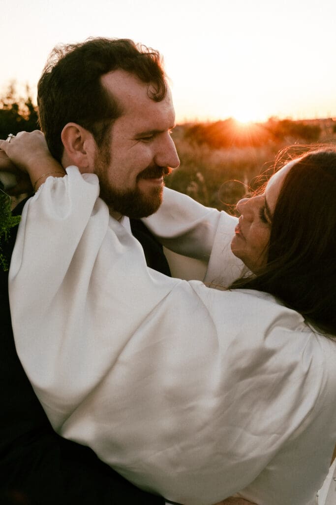 citadel beach club bride and groom portraits on beach in sunset