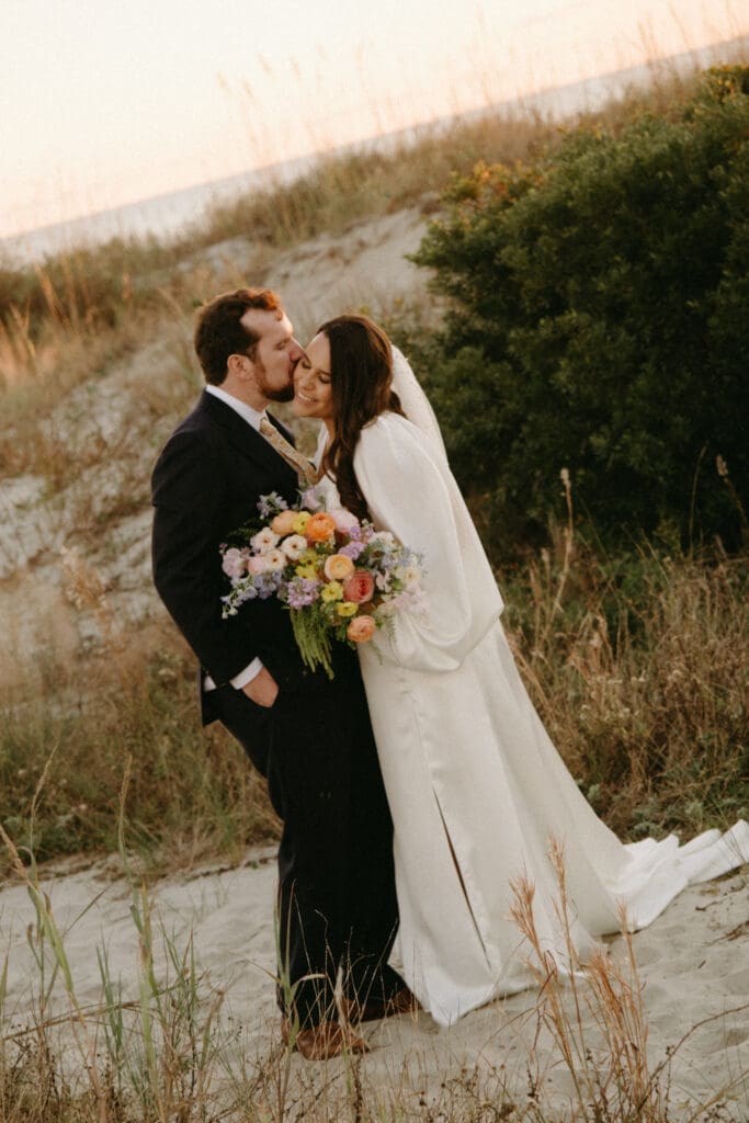 bride and groom kissing on beach isle of palms citadel beach club