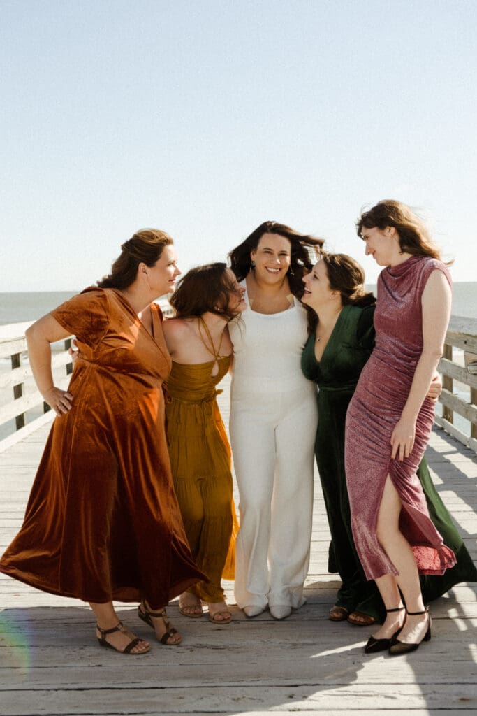 bride with bridesmaids in fall color dresses for wedding