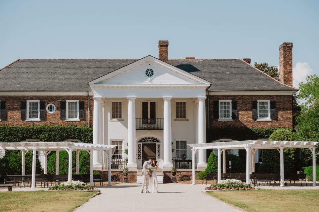 Wide architecture photo of bride and groom portrait at Boone Hall Plantation House