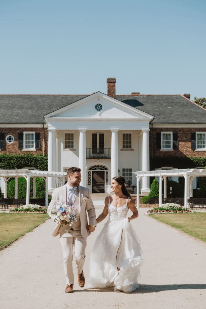 bride and groom running portrait infront of house at boone hall plantation charleston sc