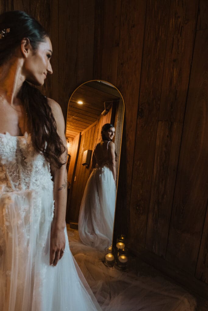 Moody bridal portrait at Cotton Dock at Boone Hall looking in mirror