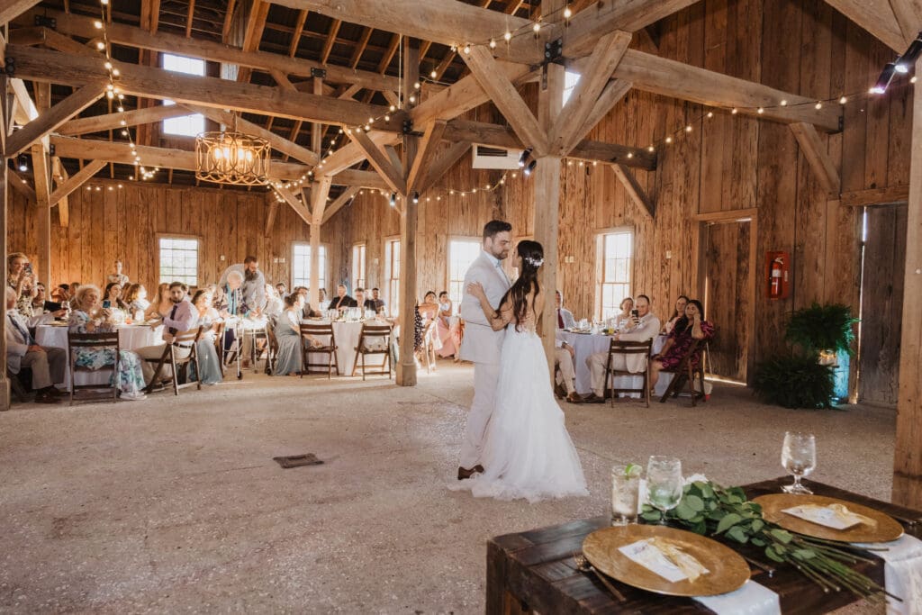 Elegant wedding reception under chandelier at Cotton Dock Boone Hall Plantation, waterfront Lowcountry