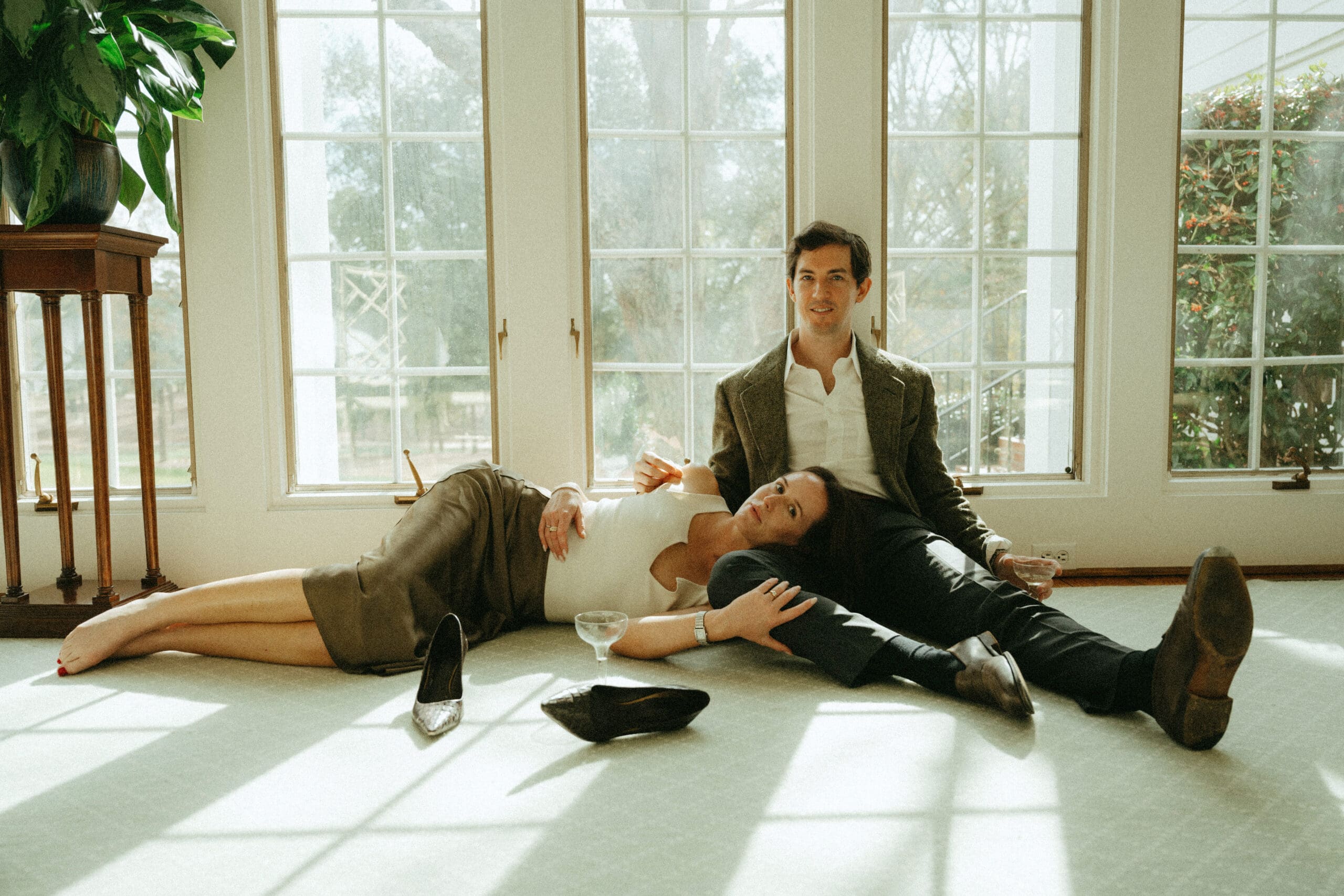 couple laying together documentary style editorial with shoes off with bright light