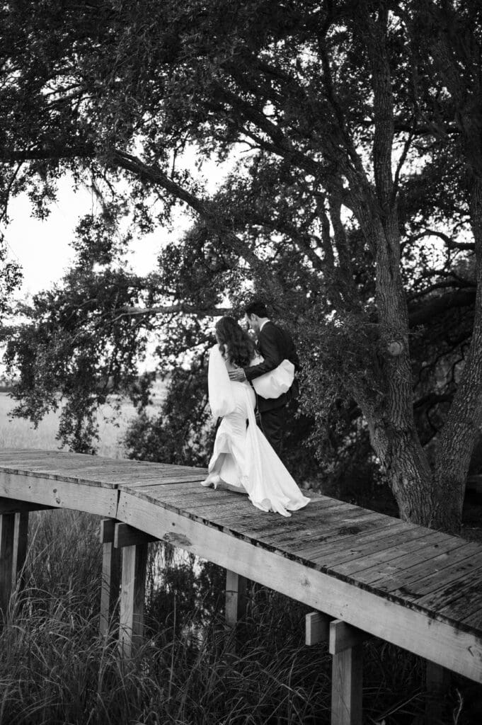 couple walking on bridge together in pawleys island 