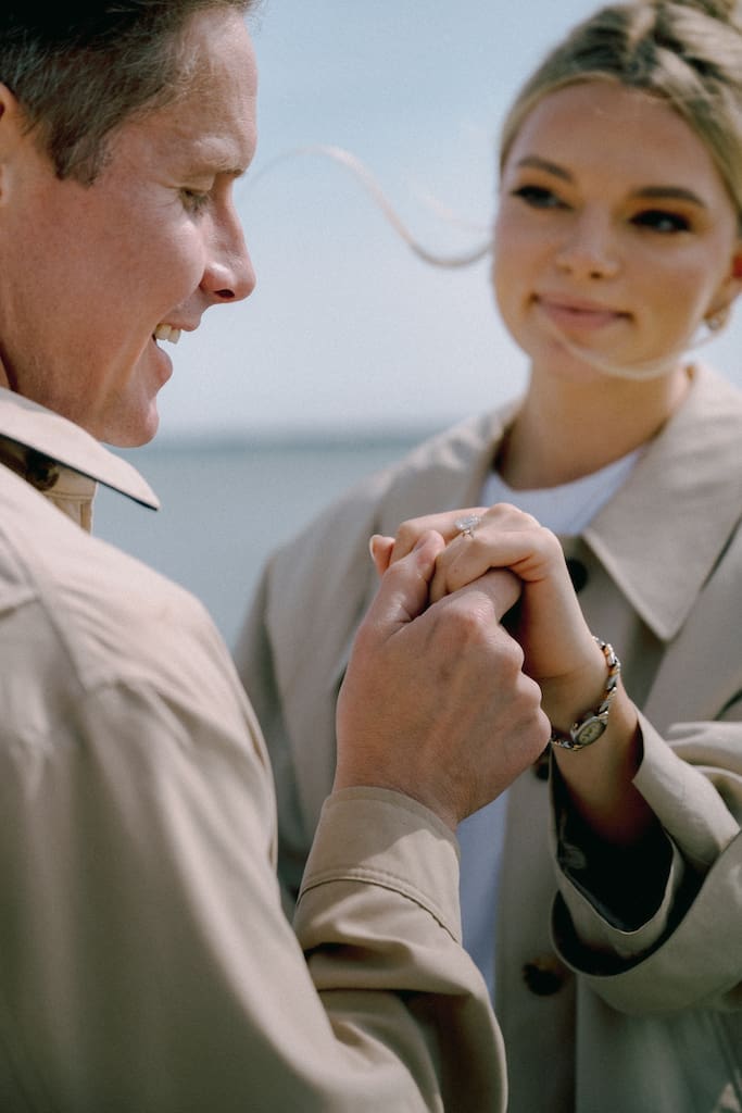 engagement ring candid photo of couple of him holding her hand