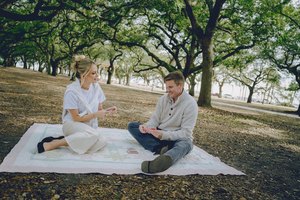 engagement shoot couple playing cards at battery park