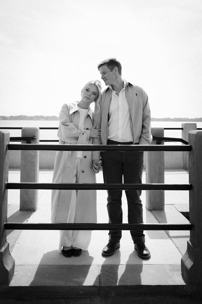 black and white photo of engagement shoot of couple in front of water at battery park charleston sc