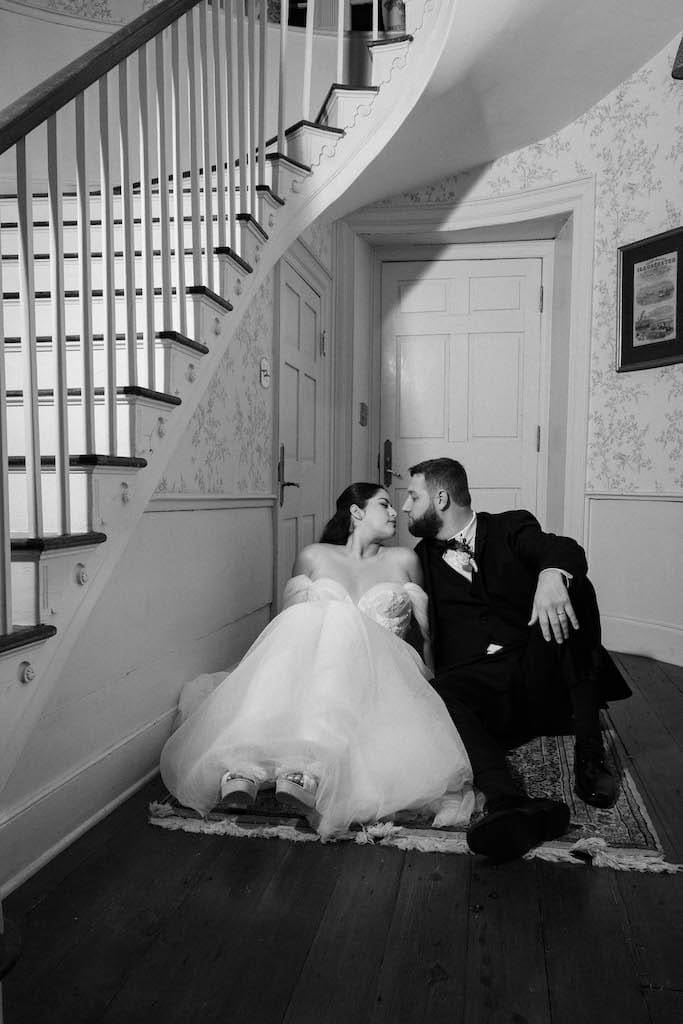 editorial portrait of couple under staircase in black and white