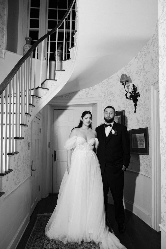 editorial portrait of couple under staircase in black and white