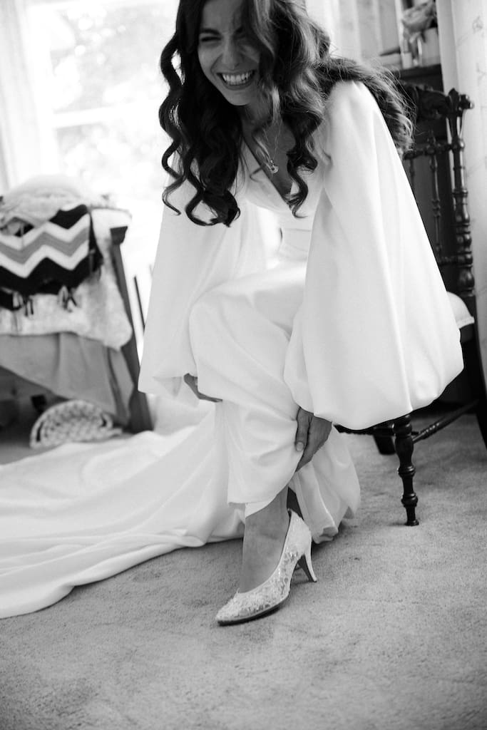 bride getting ready, candid of her shoes in black and white