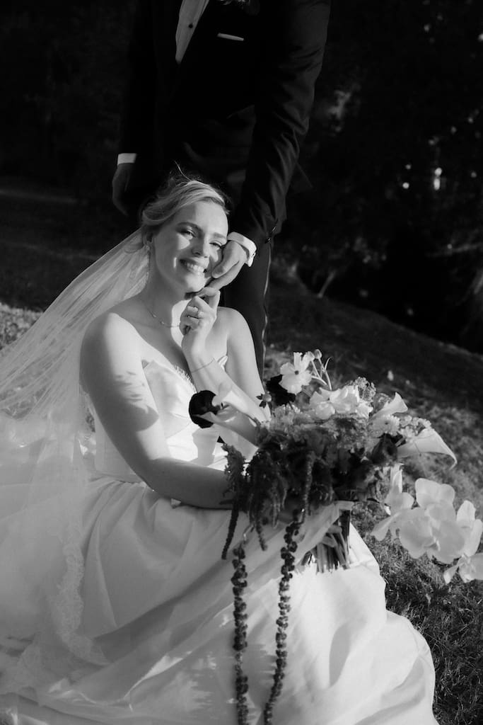 black and white portrait of bride and groom candidly posing